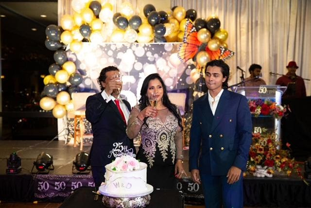 Anniversary couple Dilip and Wathsala toasting the occasion with their son Randil looking on

